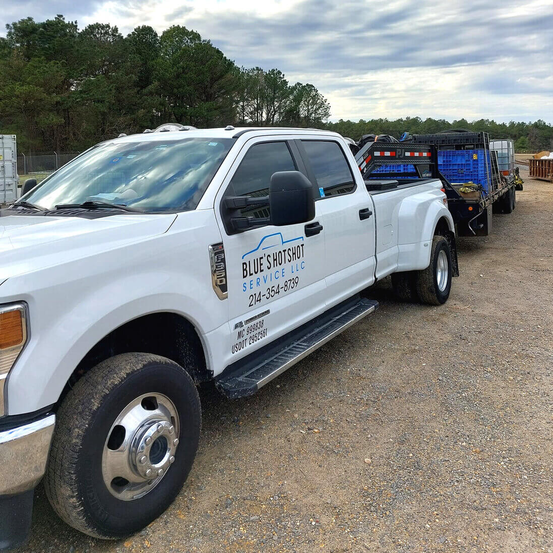 Blue's Hotshot Service dually truck transporting material.